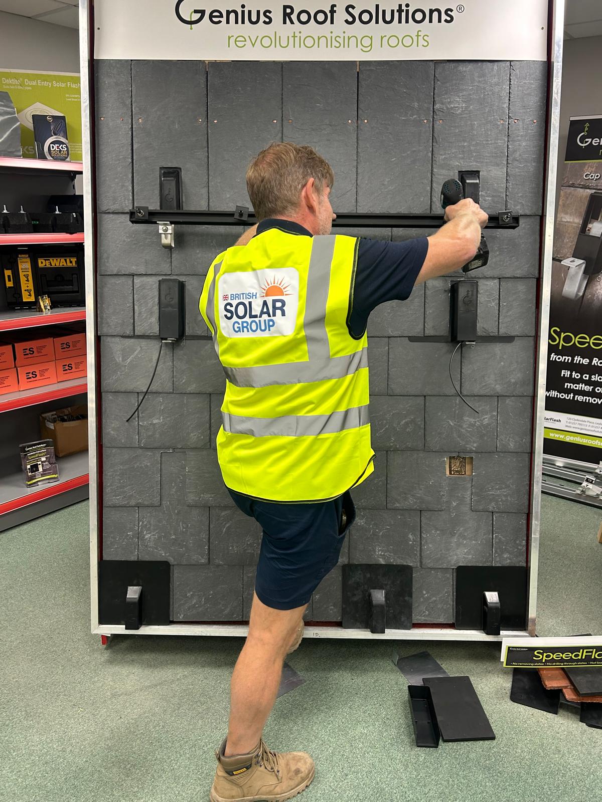 British Solar Group team member securing solar panels to the roof